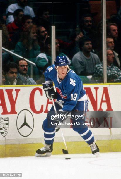 Joe Sakic of the Quebec Nordiques skates against New Jersey Devils during an NHL Hockey game circa 1990 at the Brendan Byrne Arena in East...