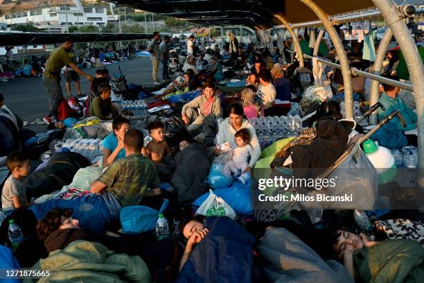 Refugees find shelter outside Lidl supermarket next to road close to Mytilene town, after a fire destroyed Moria Refugee Camp on the island of...