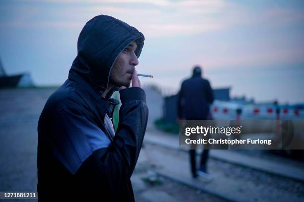 Migrants wait on the beach at St Margaret's Bay after landing by dinghy from France on September 11, 2020 in Dover, England. More than 1,468...