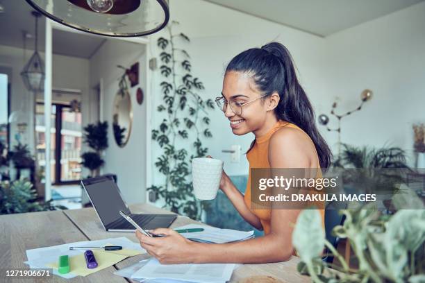 beautiful woman doing finances at home - personalised communication stock-fotos und bilder