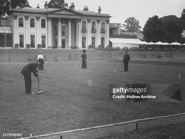 People playing croquet in the grounds of the Hurlingham Club, located in Ranelagh Gardens, Fulham, west London, England, 1910. The club's Georgian...