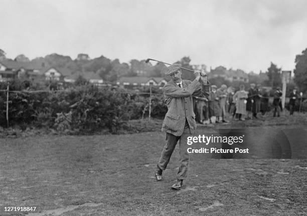 Scottish golfer James Braid on the fairway, with spectators in the background, during a tournament at Walton Heath Golf Club in Walton-on-the-Hill,...