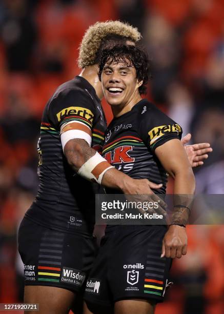 Jarome Luai of the Panthers and Viliame Kikau of the Panthers embrace after winning the round 18 NRL match between the Penrith Panthers and the...