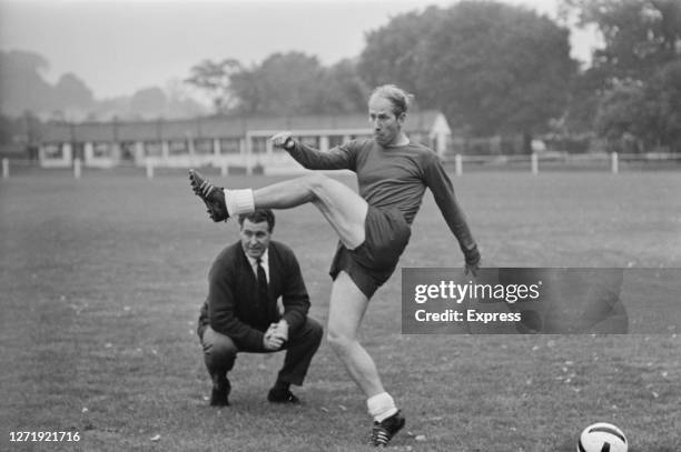 English footballer Bobby Charlton undergoes a fitness test, watched by trainer Harold Shepherdson , 1965.