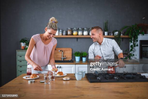 happy caucasian couple having breakfast and cooking coffee at home - turkish coffee drink stock pictures, royalty-free photos & images