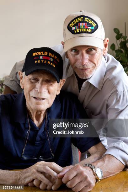 world war two veteran and son gulf war veteran at home looking at camera - dementia father stock pictures, royalty-free photos & images