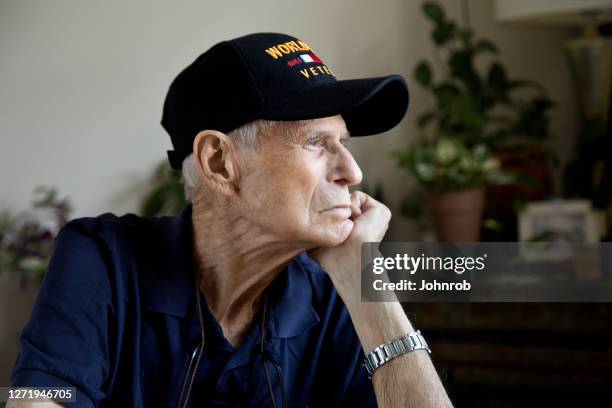 world war two veteran sitting at home looking toward window - veteran stock pictures, royalty-free photos & images