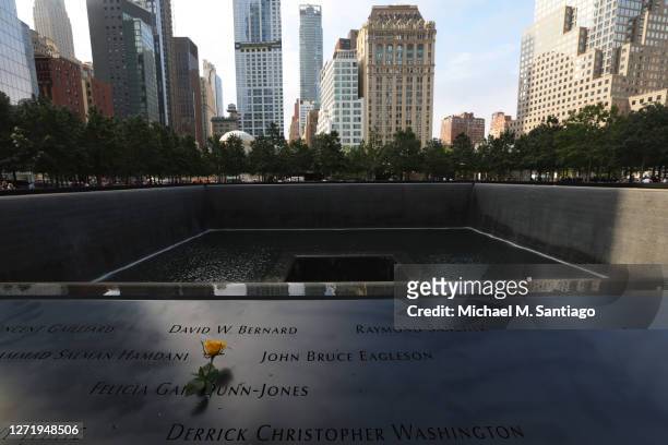 Lone flower is placed on the name plate honoring the fallen during a 9/11 memorial service at the National September 11 Memorial and Museum on...