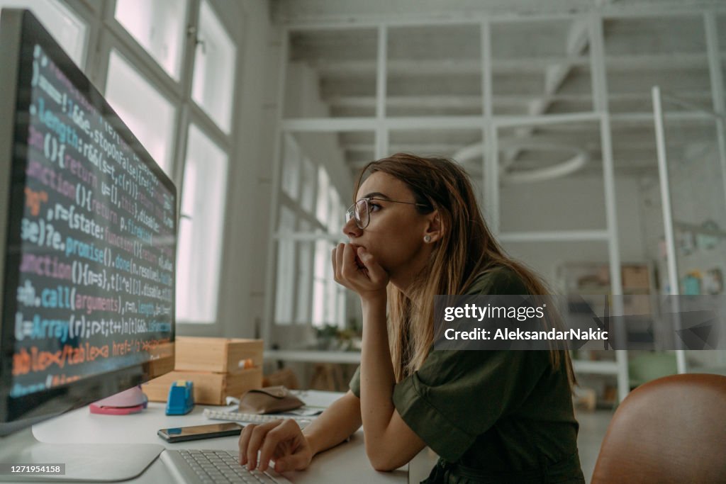 Female Programmer Coding On A Desktop Computer High-Res Stock Photo ...