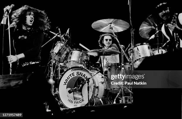 From left, English Rock musicians David Coverdale, Ian Paice, and Micky Moody, all of the group Whitesnake, perform onstage at the Rosemont Horizon,...