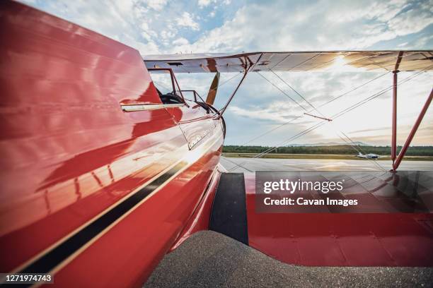 red vintage antique waco biplane at airport in maine at sunrise - red plane stock pictures, royalty-free photos & images