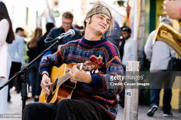 young man playing guitar in the street - galway stock pictures, royalty-free photos & images