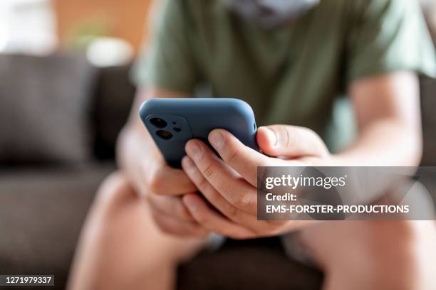 teenager boy is using smartphone at home - home schooling - child smartphone stock pictures, royalty-free photos & images