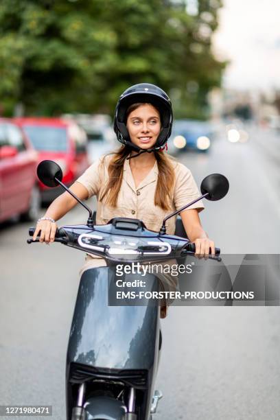 female student is driving an e-scooter in the city sofia - lambreta imagens e fotografias de stock