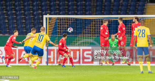 Martin Kobylanski of Eintracht Braunschweig scores his team's first goal past goalkeeper Alexander Schwolow of Hertha BSC during the DFB Cup first...