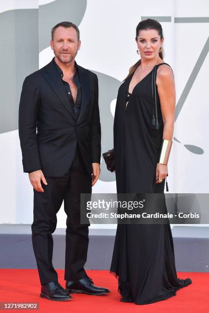 Alba Parietti and a guest walk the red carpet ahead of the movie 'Nomadland' at the 77th Venice Film Festival on September 11, 2020 in Venice, Italy.