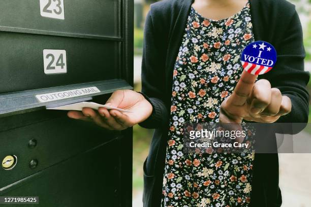 woman votes by mail - social justice concept stock pictures, royalty-free photos & images