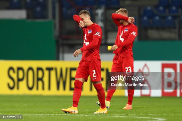 Peter Pekarik and Arne Maier of Hertha Berlin look dejected following their sides defeat in the DFB Cup first round match between Eintracht...