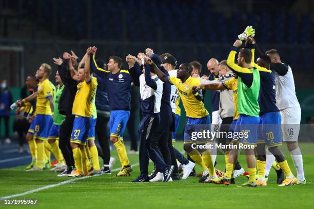 Players of Eintracht Braunschweig celebrate with fans following their victory in the DFB Cup first round match between Eintracht Braunschweig and...