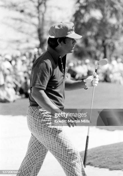 American professional golfer Lee Trevino holds his wedge as he walks out of the sand trap during the 1973 Jackie Gleason Inverrary-National Airlines...