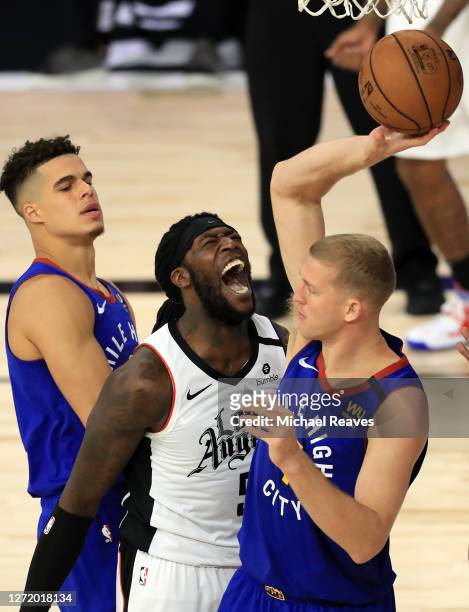 Montrezl Harrell of the LA Clippers reacts against Mason Plumlee of the Denver Nuggets \d4 in Game Five of the Western Conference Second Round during...