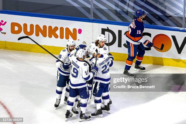 Mikhail Sergachev of the Tampa Bay Lightning is congratulated by his teammates after scoring a goal against the New York Islanders as Cal Clutterbuck...