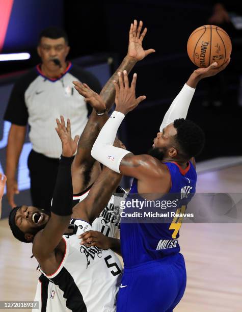 Paul Millsap of the Denver Nuggets fouls Montrezl Harrell of the LA Clippers during the fourth quarter in Game Five of the Western Conference Second...