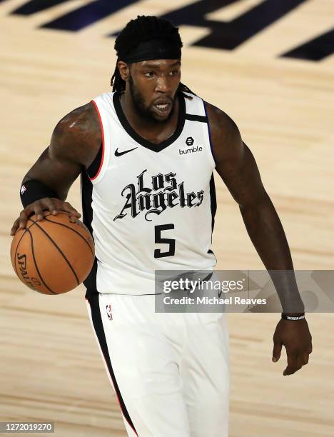 Montrezl Harrell of the LA Clippers dribbles the ball during the fourth quarter against the Denver Nuggets in Game Five of the Western Conference...