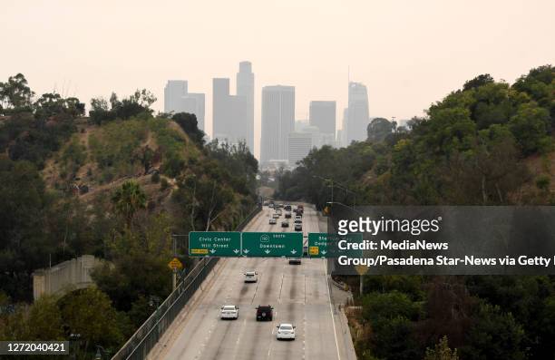 View of downtown Los Angeles looking south along the 110 freeway through the smoke from the Bobcat and the El Dorado fires with poor air quality in...