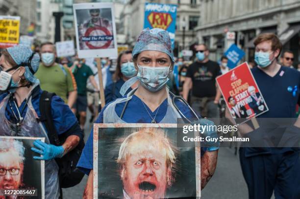 An NHS worker covered in fake blood takes part in a march from the BBC headquarters to Trafalgar square to demand a pay rise from the government on...