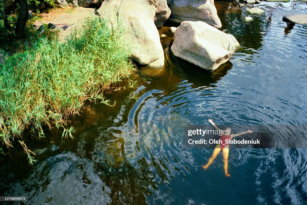 Woman swimming in river in summer