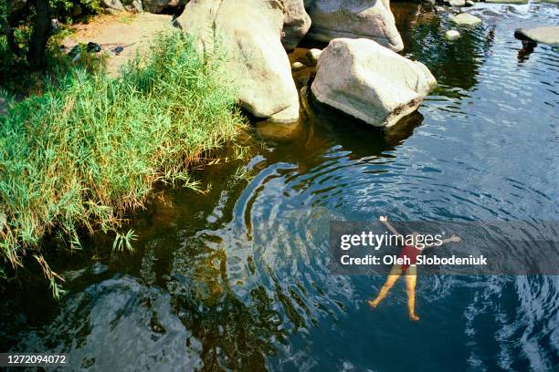 woman swimming in river in summer - analog stock pictures, royalty-free photos & images