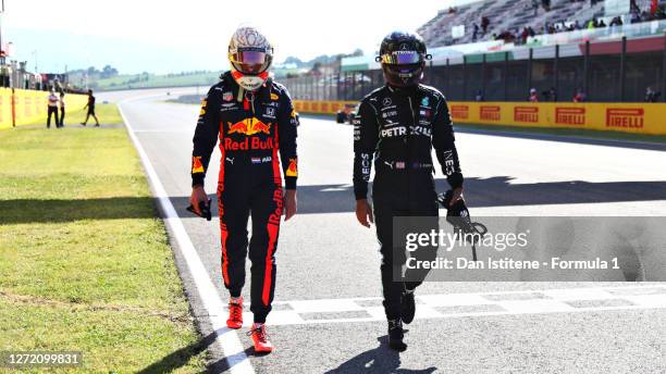 Pole position qualifier Lewis Hamilton of Great Britain and Mercedes GP and third placed qualifier Max Verstappen of Netherlands and Red Bull Racing...