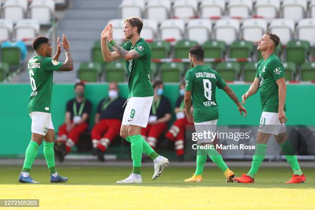 Yannick Gerhardt of Wolfsburg celebrates his team's third goal with teammates during the DFB Cup first round match between FSV Union Fürstenwalde and...