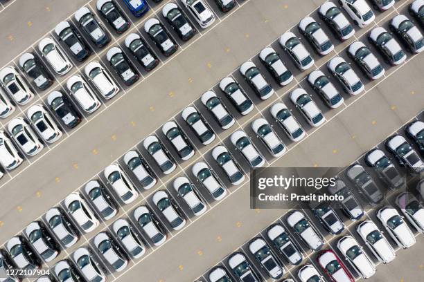 aerial view new car lined up in the port for import and export business logistic to dealership for sale, automobile and automotive car parking lot for commercial business industry. - car park stock-fotos und bilder