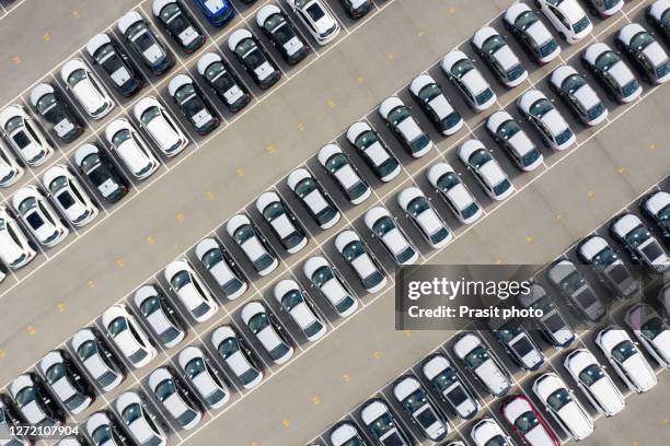 aerial view new car lined up in the port for import and export business logistic to dealership for sale, automobile and automotive car parking lot for commercial business industry. - car sale stockfoto's en -beelden
