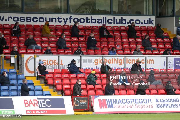 Fans look on from socially distanced positions in the stands during the Ladbrokes Scottish Premiership match between Ross County and Celtic at Global...