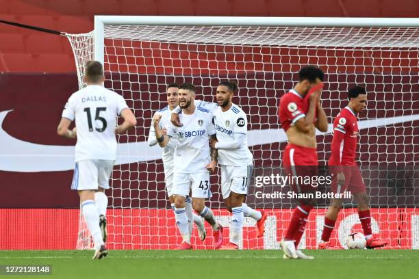 Mateusz Klich of Leeds United celebrates with teammates after scoring his team's third goal during the Premier League match between Liverpool and...