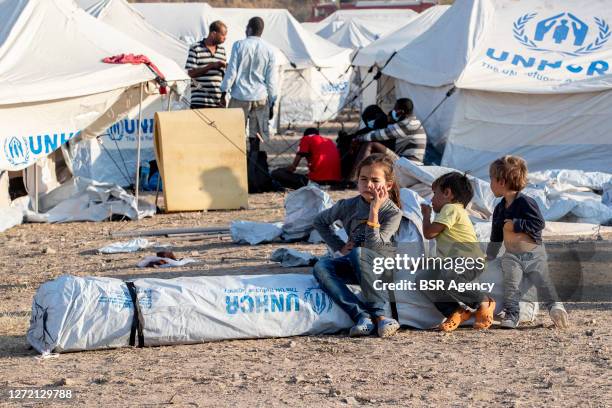 Migrant children are seen during relocation to the new UNHCR refugee camp on September 12, 2020 on Lesbos, Greece. The first migrants and refugees...