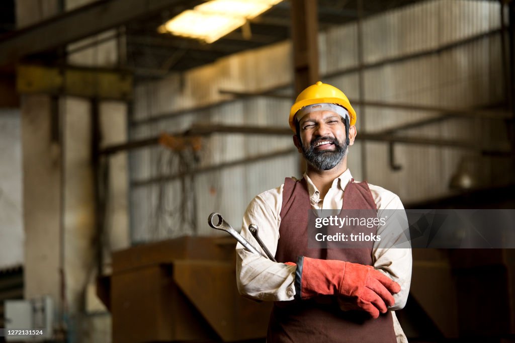 Industrial worker holding wrench