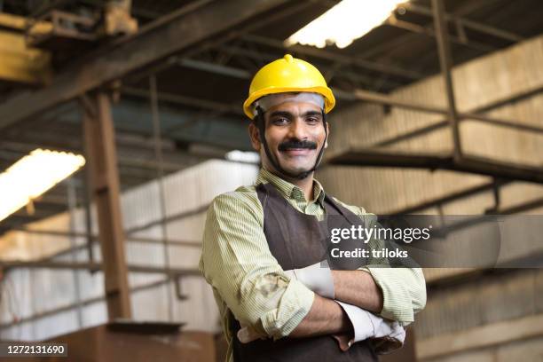 confident industrial worker in protective workwear at factory - indian factory workers stock pictures, royalty-free photos & images