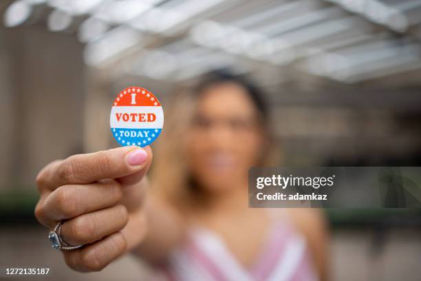young hispanic woman with i voted sticker - vote sticker stock pictures, royalty-free photos & images