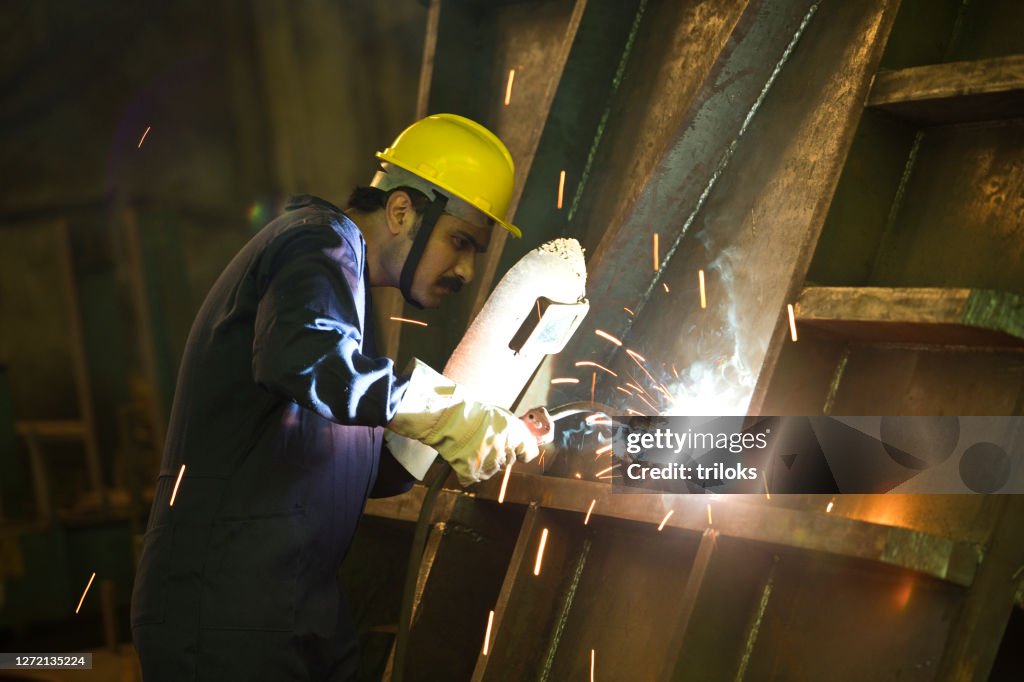 Male welder working at factory