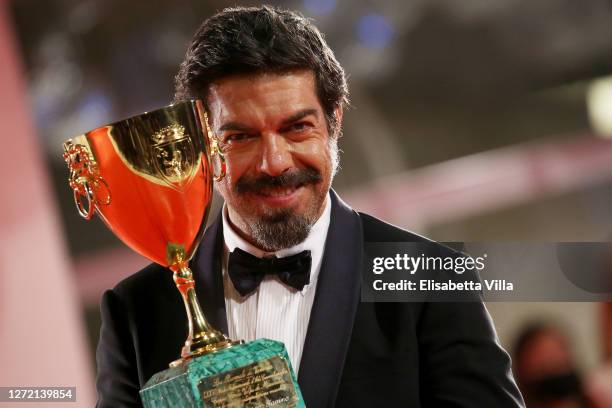 Pierfrancesco Favino poses with the Coppa Volpi for Best Actor during the winners photocall at the 77th Venice Film Festival on September 12, 2020 in...