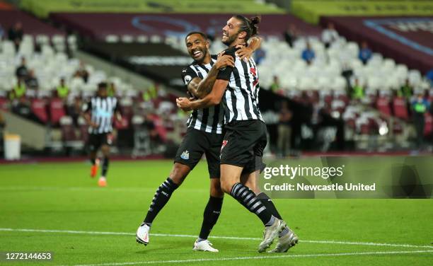 Callum Wilson of Newcastle United celebrates with teammate Andy Carroll after scoring his team's first goal during the Premier League match between...