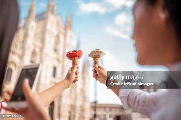 young women taking a photo of ice cream - milan food stock pictures, royalty-free photos & images