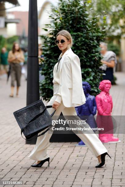 Vice Miss Germany 2020 and Influencer Lara Runarsson wearing a cream colored blazer and matching pants by Sandro Paris, a gold necklace by Thomas...