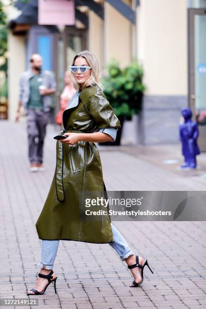 Vice Miss Germany 2020 and Influencer Lara Runarsson wearing a long khaki colored and blue/white checkered laminated reversible coat by Dorothee...