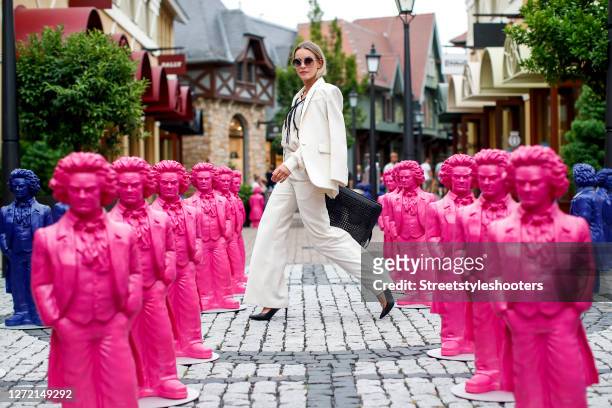 Vice Miss Germany 2020 and Influencer Lara Runarsson wearing a cream colored blazer and matching pants by Sandro Paris, a gold necklace by Thomas...