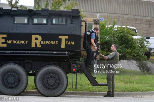 Member of the Jackson County Sheriff's Emergency Response Team exits an armored vehicle as police are involved in a standoff with gunman at the...